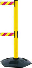 Tensator - 38" High, 2-1/2" Pole Diam, 4 Way Stanchion - 19" Base Diam, Octagon Recycled Rubber Base, Yellow Plastic Post, 13' x 2" Tape, Dual Line Tape, For Outdoor Use - Caliber Tooling